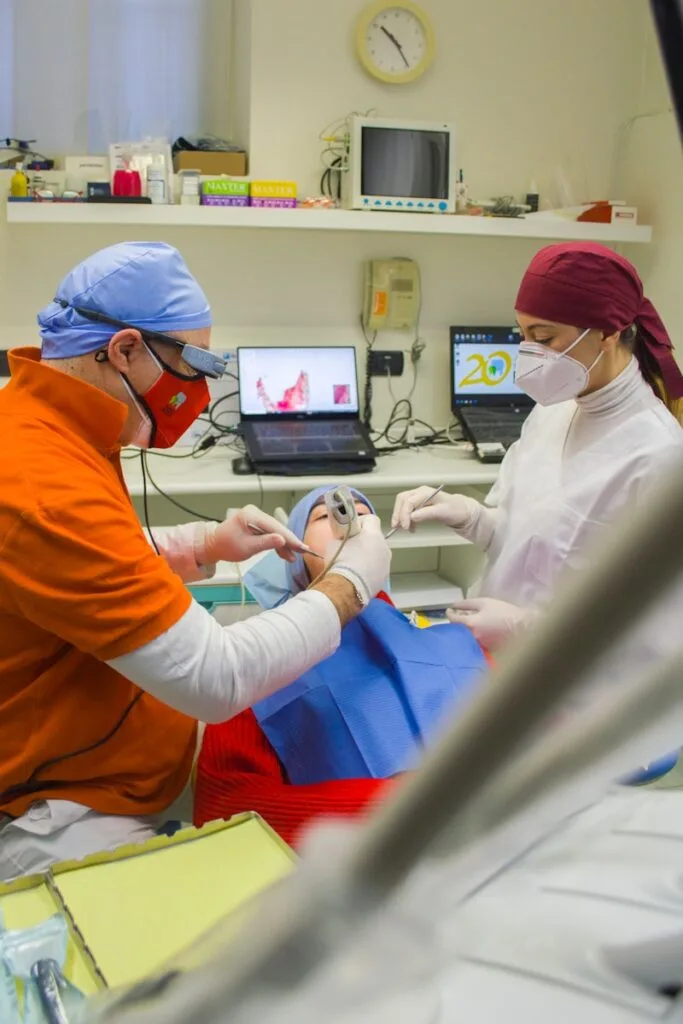 dentist and dental assistant wearing medical scrub caps